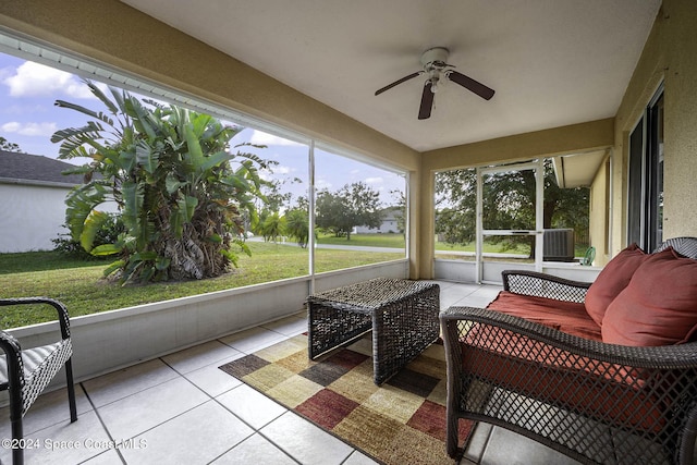 sunroom / solarium featuring ceiling fan