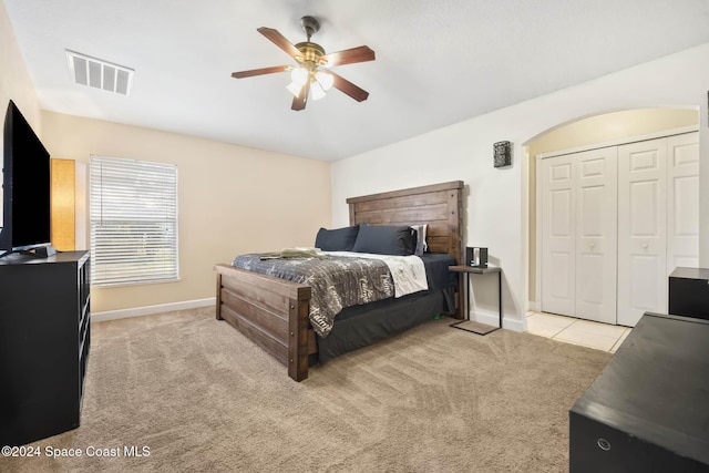 carpeted bedroom featuring a closet and ceiling fan