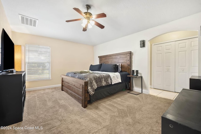 2773 San Filippo Dr SE, Palm Bay, FL 32909 - bedroom featuring light carpet, ceiling fan, and a closet
