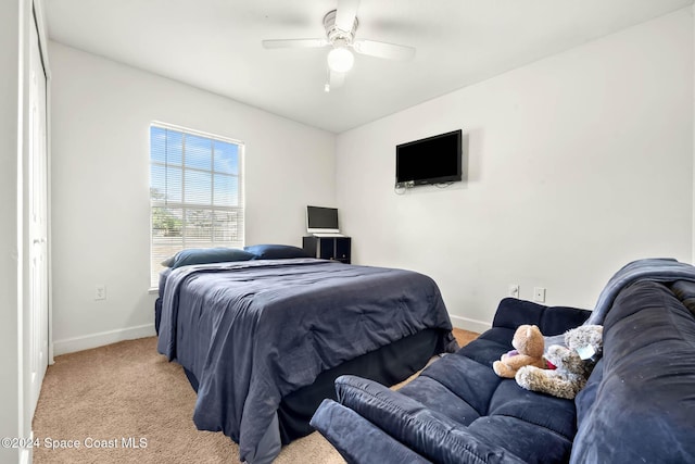 bedroom featuring light carpet and ceiling fan