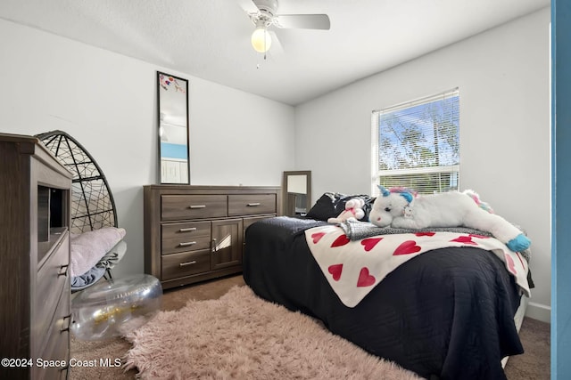 carpeted bedroom featuring ceiling fan