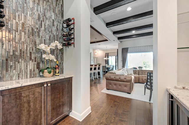 corridor with beamed ceiling and dark hardwood / wood-style flooring