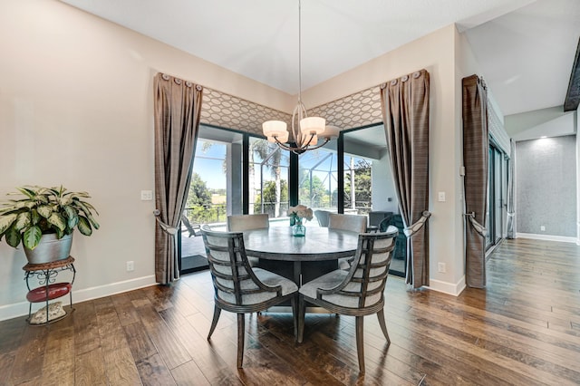 dining space featuring dark wood-type flooring and a notable chandelier