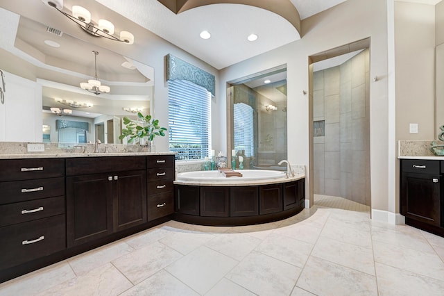 bathroom featuring shower with separate bathtub and vanity