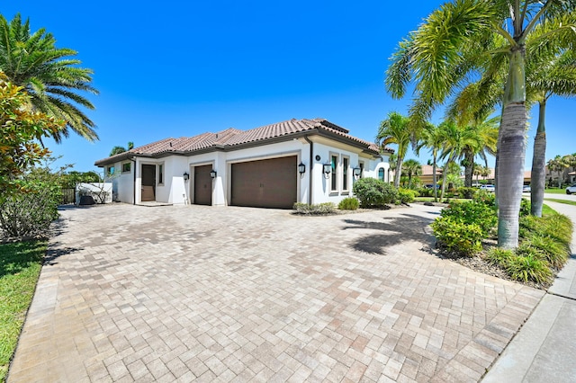 mediterranean / spanish-style house with a garage