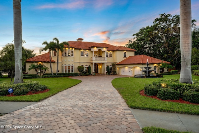 4760 Honeyridge Ln, Merritt Island, FL 32952 - mediterranean / spanish-style house with decorative driveway, a balcony, a front yard, an attached garage, and a chimney