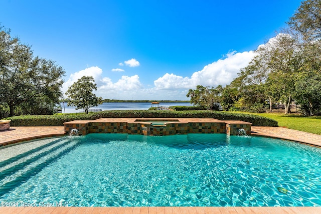 view of pool featuring an in ground hot tub, pool water feature, and a water view