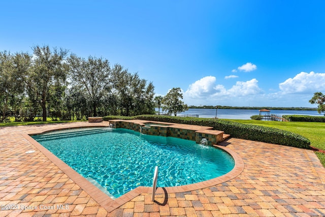 view of swimming pool featuring pool water feature, a patio area, a water view, and an in ground hot tub