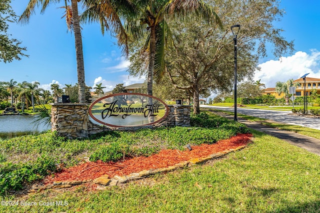 community / neighborhood sign with a water view