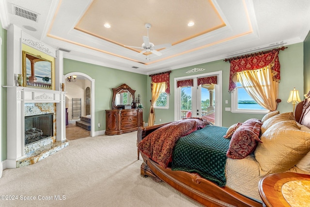 bedroom featuring access to outside, a raised ceiling, ceiling fan, and ornamental molding