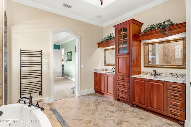 bathroom featuring a bathing tub, vanity, radiator, and crown molding