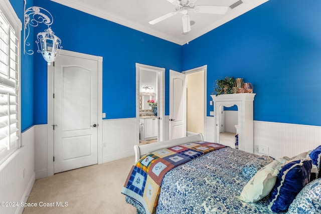 carpeted bedroom featuring connected bathroom, ceiling fan, and ornamental molding