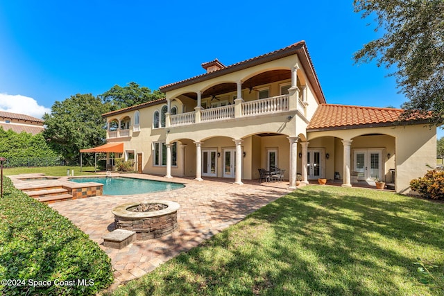 rear view of property with a patio area, ceiling fan, french doors, and an outdoor fire pit