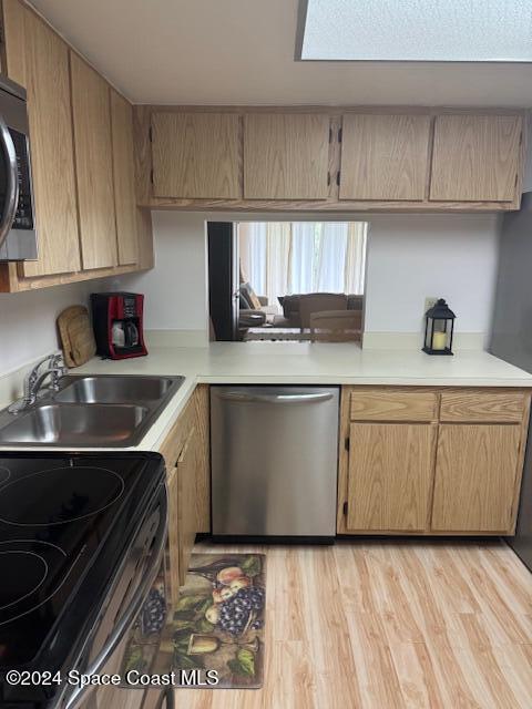 kitchen featuring light hardwood / wood-style floors, sink, and appliances with stainless steel finishes