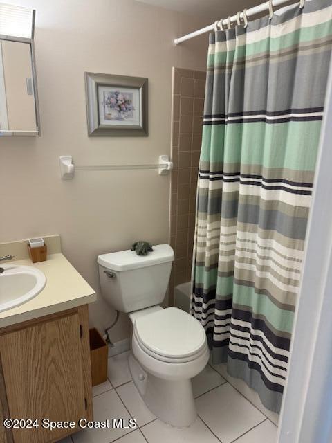 full bathroom with tile patterned floors, vanity, shower / bath combo, and toilet