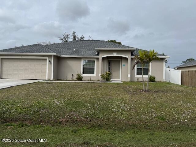 single story home featuring a front lawn and a garage