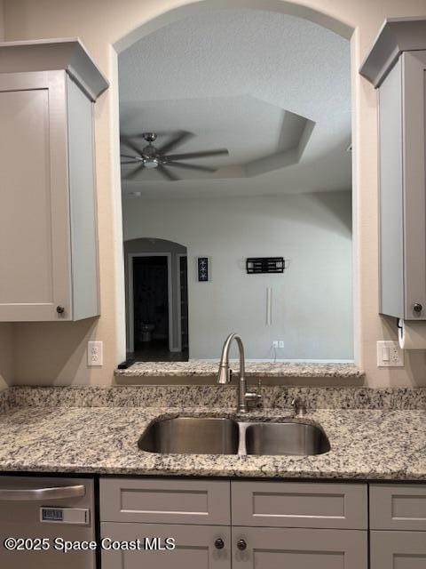 kitchen with sink, gray cabinets, light stone countertops, and dishwasher