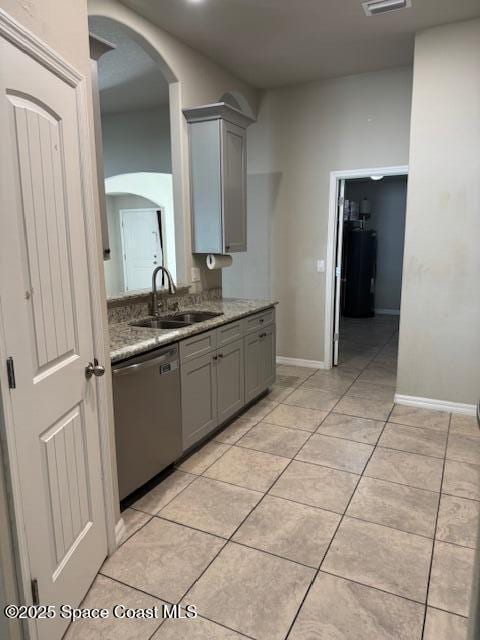 kitchen featuring gray cabinets, sink, dishwasher, and light tile patterned flooring