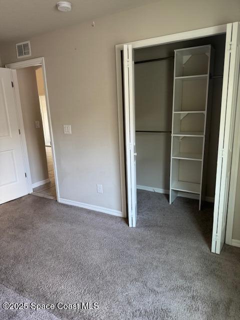 unfurnished bedroom with a closet and carpet floors