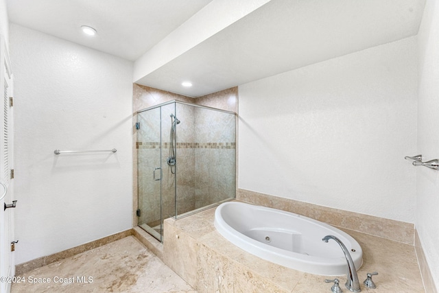 bathroom featuring separate shower and tub