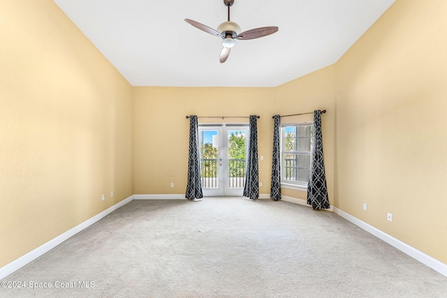 carpeted spare room featuring ceiling fan