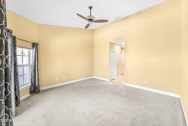 carpeted spare room featuring ceiling fan