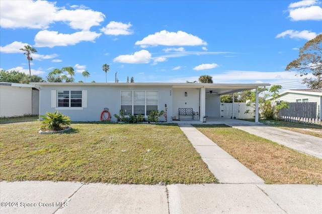 single story home with a front lawn and a carport