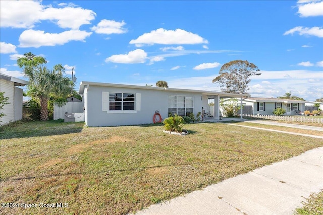 ranch-style home with a front yard and a carport