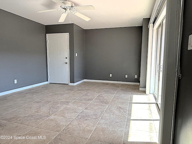 unfurnished room featuring ceiling fan and light tile patterned flooring