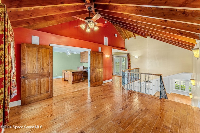 living room with vaulted ceiling with beams, ceiling fan, and light hardwood / wood-style floors