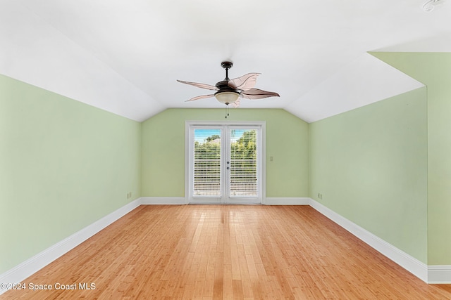 additional living space with french doors, light wood-type flooring, ceiling fan, and lofted ceiling