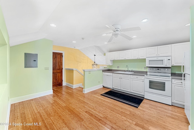 kitchen featuring white appliances, vaulted ceiling, sink, light hardwood / wood-style floors, and white cabinetry