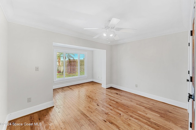 empty room featuring ceiling fan, crown molding, and light hardwood / wood-style flooring