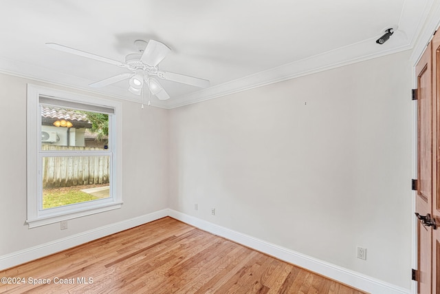 spare room with ceiling fan, hardwood / wood-style floors, and crown molding