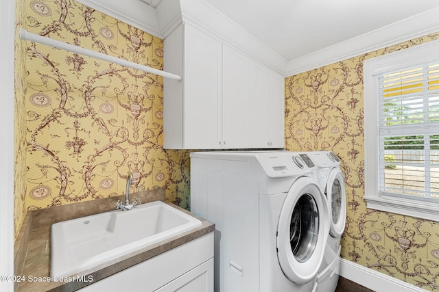 laundry area with separate washer and dryer, sink, cabinets, and ornamental molding