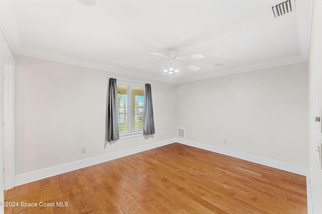 spare room featuring crown molding, ceiling fan, and hardwood / wood-style flooring