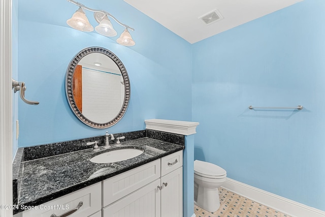 bathroom featuring vanity and toilet