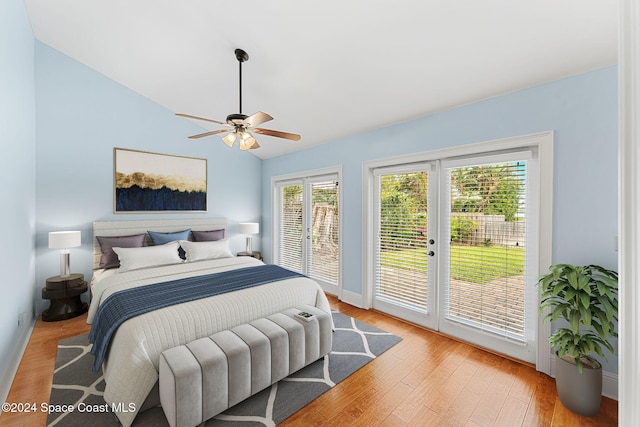 bedroom featuring light wood-type flooring, access to outside, vaulted ceiling, and ceiling fan