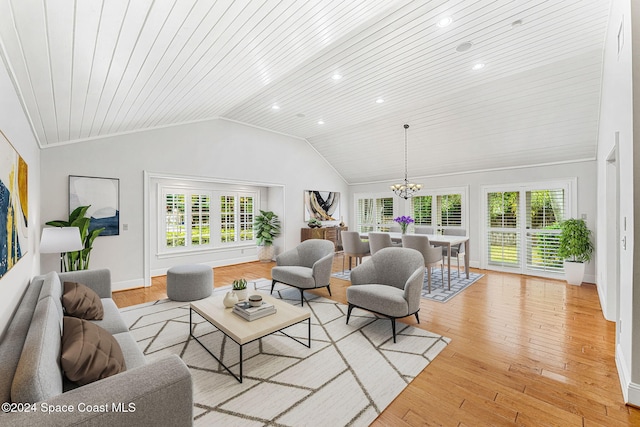 living room featuring wood ceiling, a chandelier, light hardwood / wood-style floors, and vaulted ceiling