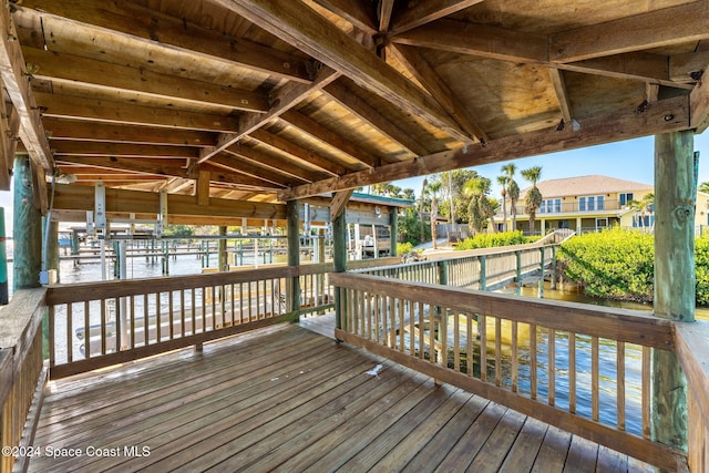 wooden terrace featuring a water view