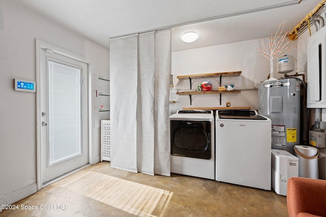 laundry area with washing machine and clothes dryer, electric water heater, and a textured ceiling