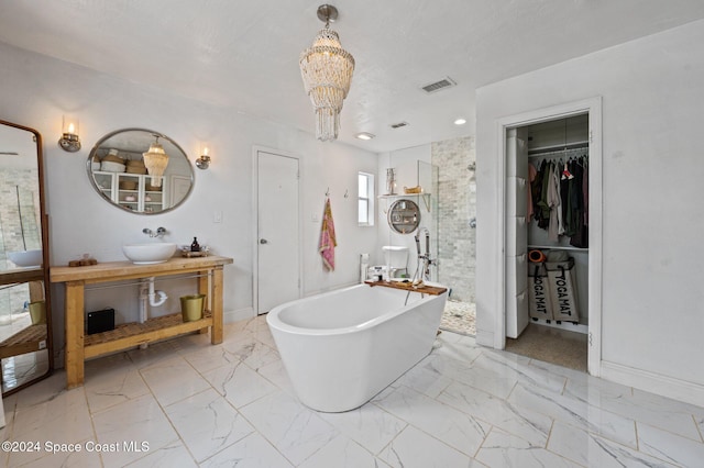 bathroom with vanity, independent shower and bath, and an inviting chandelier