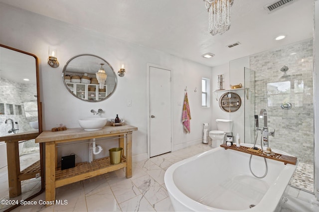 full bathroom with shower with separate bathtub, vanity, toilet, and a notable chandelier