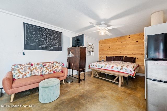 bedroom with wooden walls and ceiling fan