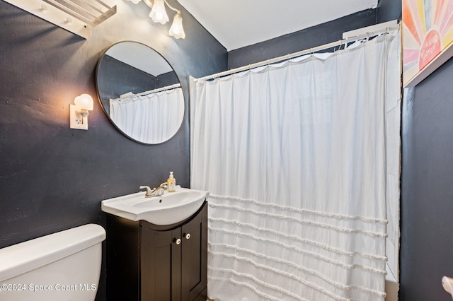 bathroom featuring vanity and toilet