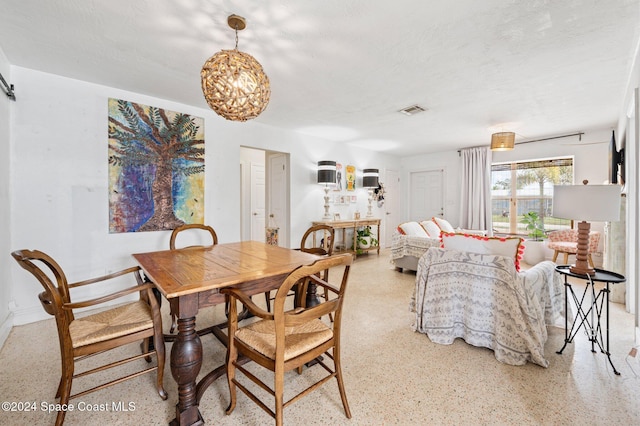 dining area with a textured ceiling