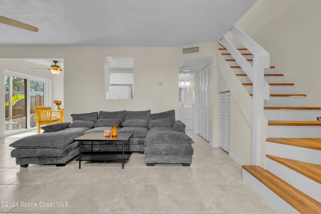 516 S Plumosa St Unit 20, Merritt Island, FL 32952 - living area featuring stairs, a ceiling fan, and light tile patterned flooring