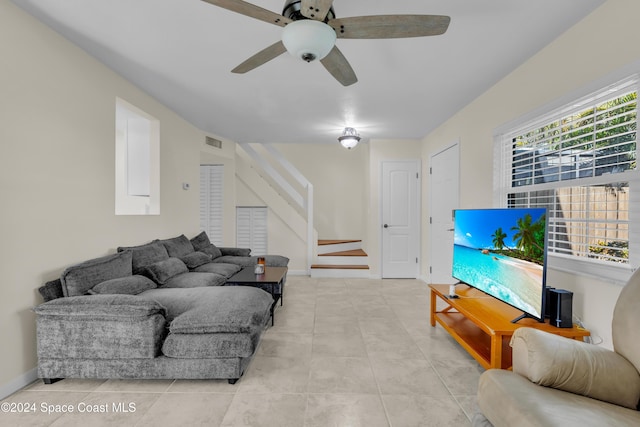 tiled living room with ceiling fan