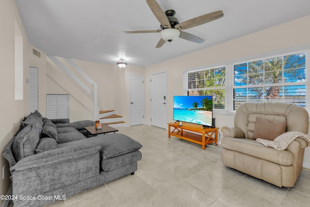 living room featuring ceiling fan and light tile patterned floors