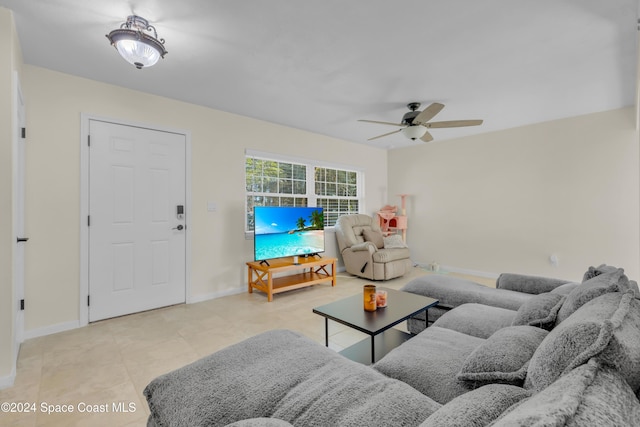 tiled living room with ceiling fan